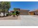 Charming single-story home with a well-maintained front yard and a two-car garage at 5659 N 195Th Dr, Litchfield Park, AZ 85340