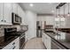 Contemporary kitchen featuring white cabinets, stainless steel appliances, and decorative backsplash tiles at 5659 N 195Th Dr, Litchfield Park, AZ 85340