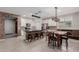 Bright kitchen with a dining area, island seating, stainless appliances, and an open floor plan at 5659 N 195Th Dr, Litchfield Park, AZ 85340