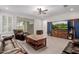 Bright living room with tile flooring and a custom media cabinet at 5659 N 195Th Dr, Litchfield Park, AZ 85340