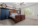 Main bedroom with beautiful blue accent wall and decorative wood trim at 5659 N 195Th Dr, Litchfield Park, AZ 85340