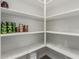 Walk-in pantry features built-in shelving for optimal storage at 5659 N 195Th Dr, Litchfield Park, AZ 85340