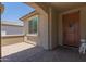 Cozy covered porch with brick flooring, stucco walls, and a decorative welcome sign at 5659 N 195Th Dr, Litchfield Park, AZ 85340