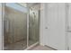 Walk-in shower features glass door, tiled walls, and unique showerhead at 5659 N 195Th Dr, Litchfield Park, AZ 85340