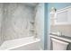 Well-lit bathroom with a shower-tub combo and built in corner shelves, along with a linen closet at 620 S Allred Dr, Tempe, AZ 85288