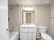 Bathroom featuring tiled shower, white vanity, and neutral paint at 620 S Allred Dr, Tempe, AZ 85288