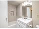 Bathroom featuring tiled shower, white vanity, and neutral paint at 620 S Allred Dr, Tempe, AZ 85288