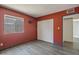 Bedroom with wood floors, neutral paint, window, and closet at 620 S Allred Dr, Tempe, AZ 85288