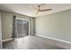 Spacious bedroom with wood grain vinyl floors, and a sliding glass door leading to the patio at 620 S Allred Dr, Tempe, AZ 85288