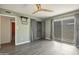 A large bedroom with wood grain vinyl floors, large windows, and access to an adjacent room at 620 S Allred Dr, Tempe, AZ 85288