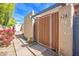 Inviting gated courtyard entrance with a secure wooden gate and mature plants at 620 S Allred Dr, Tempe, AZ 85288