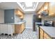 Updated kitchen featuring stainless steel appliances, granite counters, tile backsplash, and skylight at 620 S Allred Dr, Tempe, AZ 85288