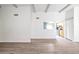 Bright living room with laminate flooring and an open kitchen layout at 620 S Allred Dr, Tempe, AZ 85288