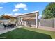Landscaped backyard features a pool, covered patio, outdoor kitchen, and synthetic lawn at 6715 S Lakeshore Dr, Tempe, AZ 85283