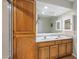 Bathroom with double sinks, wood cabinets and drawers, and a full mirror with lighting at 6715 S Lakeshore Dr, Tempe, AZ 85283