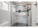 Bathroom showcasing a glass-enclosed shower with tile surround and tiled floor at 6715 S Lakeshore Dr, Tempe, AZ 85283