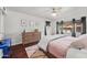 Bright bedroom featuring a ceiling fan, wood floors, area rug, and view to outdoor space at 6715 S Lakeshore Dr, Tempe, AZ 85283