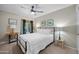 Bright bedroom featuring a queen bed, ceiling fan, and window to outdoor space at 6715 S Lakeshore Dr, Tempe, AZ 85283