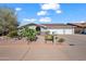 Charming single-story home featuring desert landscaping, a three-car garage, and an inviting arched entryway at 6715 S Lakeshore Dr, Tempe, AZ 85283