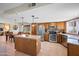 Spacious kitchen featuring stainless steel appliances, an island, and an adjacent dining area at 6715 S Lakeshore Dr, Tempe, AZ 85283