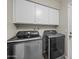 Laundry room featuring modern washer and dryer, and storage above at 6715 S Lakeshore Dr, Tempe, AZ 85283