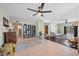 Bright, open living room featuring tile flooring, modern ceiling fan, and comfortable seating arrangements at 6715 S Lakeshore Dr, Tempe, AZ 85283