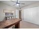 Office area featuring a ceiling fan, desk with cabinets and drawers, and view to entryway at 6715 S Lakeshore Dr, Tempe, AZ 85283
