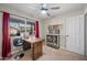 Bright office featuring a ceiling fan, desk with chair, and view to outdoor space at 6715 S Lakeshore Dr, Tempe, AZ 85283