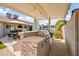 Covered outdoor kitchen with stone accents, stainless steel grill, and a built-in countertop for cooking at 6715 S Lakeshore Dr, Tempe, AZ 85283