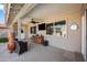 Covered patio with ceiling fan, TV, and a sitting area perfect for relaxing and entertaining at 6715 S Lakeshore Dr, Tempe, AZ 85283