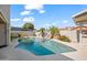 Backyard pool with waterfall feature, surrounded by lush landscaping and patio space for outdoor enjoyment at 6715 S Lakeshore Dr, Tempe, AZ 85283