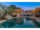 Backyard pool with lights and a covered bar area, perfect for outdoor entertaining in the evening at 6715 S Lakeshore Dr, Tempe, AZ 85283