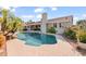 Home featuring a private pool surrounded by lush landscaping, a covered patio, and a spacious deck at 6715 S Lakeshore Dr, Tempe, AZ 85283