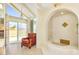 Bright bathroom features a unique corner soaking tub and an adjacent sitting area at 7115 E Buena Terra Way, Paradise Valley, AZ 85253