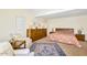 Bright bedroom boasts a vaulted ceiling, wooden dressers, and classic furniture with shuttered windows at 7115 E Buena Terra Way, Paradise Valley, AZ 85253