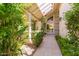 Inviting entryway with tiled flooring, a charming water feature, and lush landscaping at 7115 E Buena Terra Way, Paradise Valley, AZ 85253