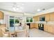 Bright kitchen with wooden cabinets, black appliances, a breakfast table and sliding glass doors to the patio at 7115 E Buena Terra Way, Paradise Valley, AZ 85253