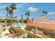 Resort-style community pool surrounded by lush palm trees and meticulously maintained landscaping at 7115 E Buena Terra Way, Paradise Valley, AZ 85253