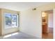A sunny bedroom with neutral colors and a view into the bathroom at 7350 N Via Paseo Del Sur -- # N207, Scottsdale, AZ 85258