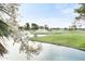 Scenic view of lush golf course with mature trees and water features, enhanced by sprinklers at 7350 N Via Paseo Del Sur -- # N207, Scottsdale, AZ 85258