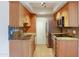 Galley kitchen with stainless steel appliances, granite counters, and tile flooring at 7350 N Via Paseo Del Sur -- # N207, Scottsdale, AZ 85258