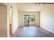 Bright living room with wood floors, sliding doors to a balcony, and neutral paint at 7350 N Via Paseo Del Sur -- # N207, Scottsdale, AZ 85258