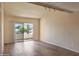 Well-lit living room with wood flooring and sliding glass doors leading to a balcony at 7350 N Via Paseo Del Sur -- # N207, Scottsdale, AZ 85258