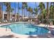Inviting community pool with lounge chairs and shaded seating amid swaying palm trees at 7350 N Via Paseo Del Sur -- # N207, Scottsdale, AZ 85258