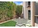 Private backyard with a modern patio and lush green landscaping at 7409 E Pleasant Run, Scottsdale, AZ 85258