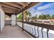 Open air balcony area with metal railings showcasing exterior views of lush foliage and community at 7409 E Pleasant Run, Scottsdale, AZ 85258