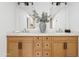 Bright bathroom with a double sink vanity, decorative mirror and lighting, and white countertops at 7409 E Pleasant Run, Scottsdale, AZ 85258