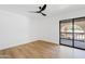 Bright bedroom with laminate flooring and a sliding glass door to a balcony at 7409 E Pleasant Run, Scottsdale, AZ 85258