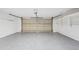 Clean garage featuring an epoxy floor, bright lighting, and ample space for parking and storage at 7409 E Pleasant Run, Scottsdale, AZ 85258
