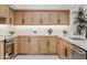 Bright, modern kitchen featuring light wood cabinets, a tiled backsplash, and stainless steel appliances at 7409 E Pleasant Run, Scottsdale, AZ 85258